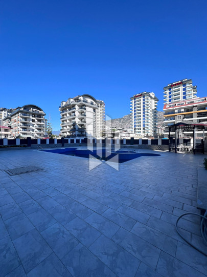 A cozy 1+1 apartment is for rent in a new and well-maintained complex in the Mahmutlar district 2