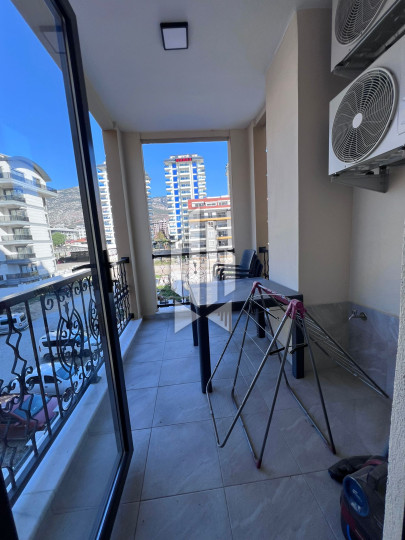 A cozy 1+1 apartment is for rent in a new and well-maintained complex in the Mahmutlar district 4