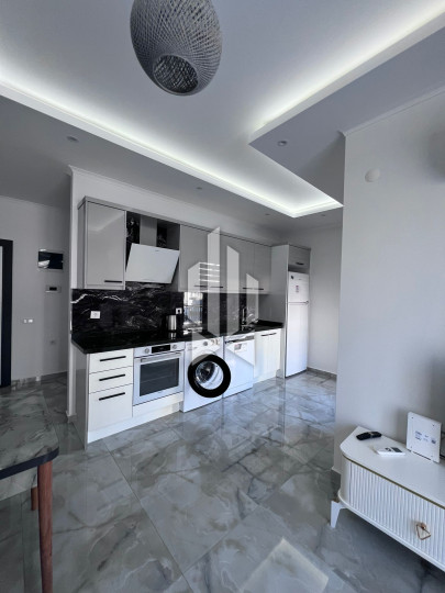 A cozy 1+1 apartment is for rent in a new and well-maintained complex in the Mahmutlar district 5