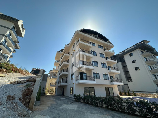 Новая квартира 1+1 в районе Оба — дом 2025 года